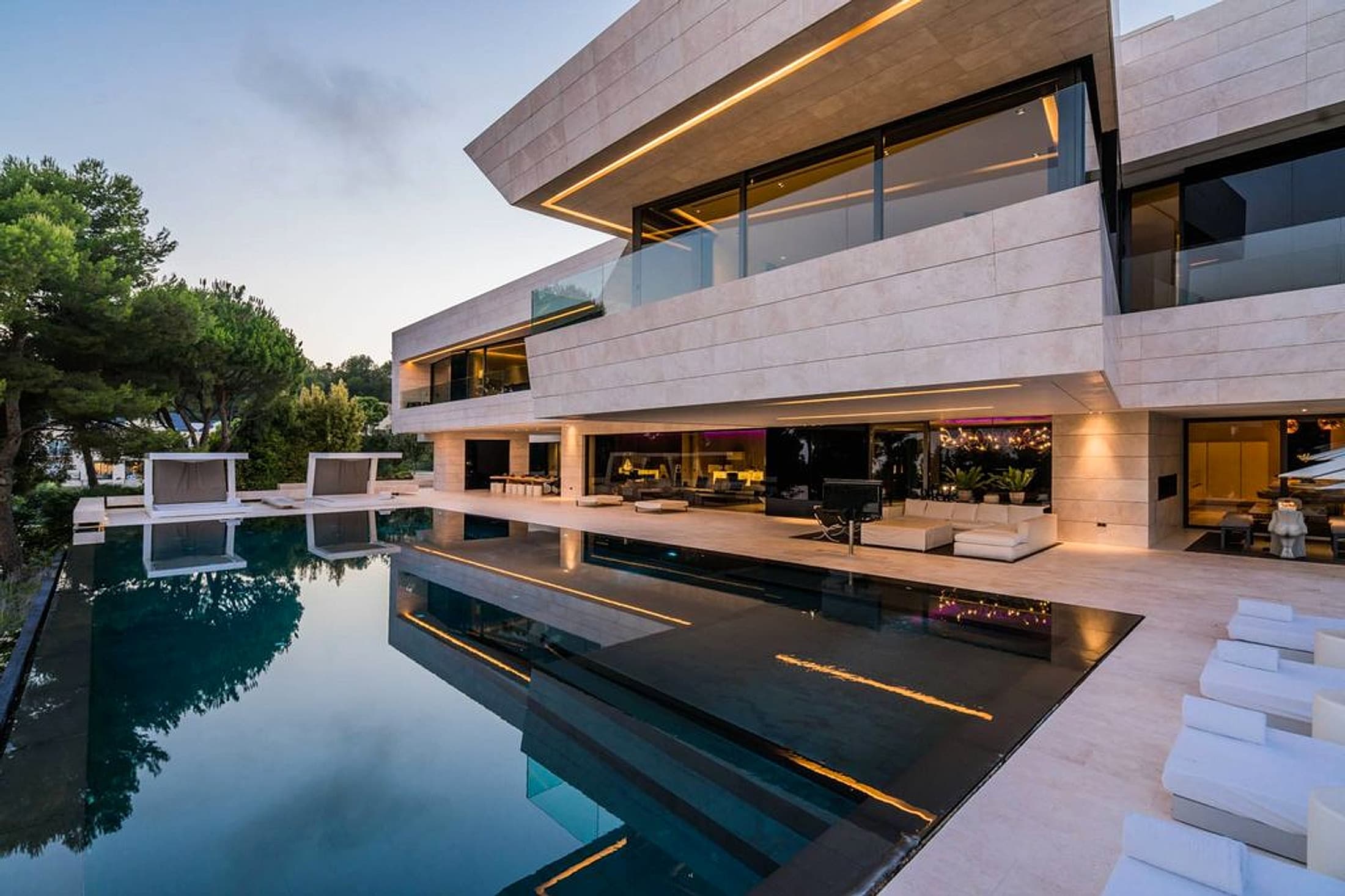 Modern house pool terrace glowing at twilight