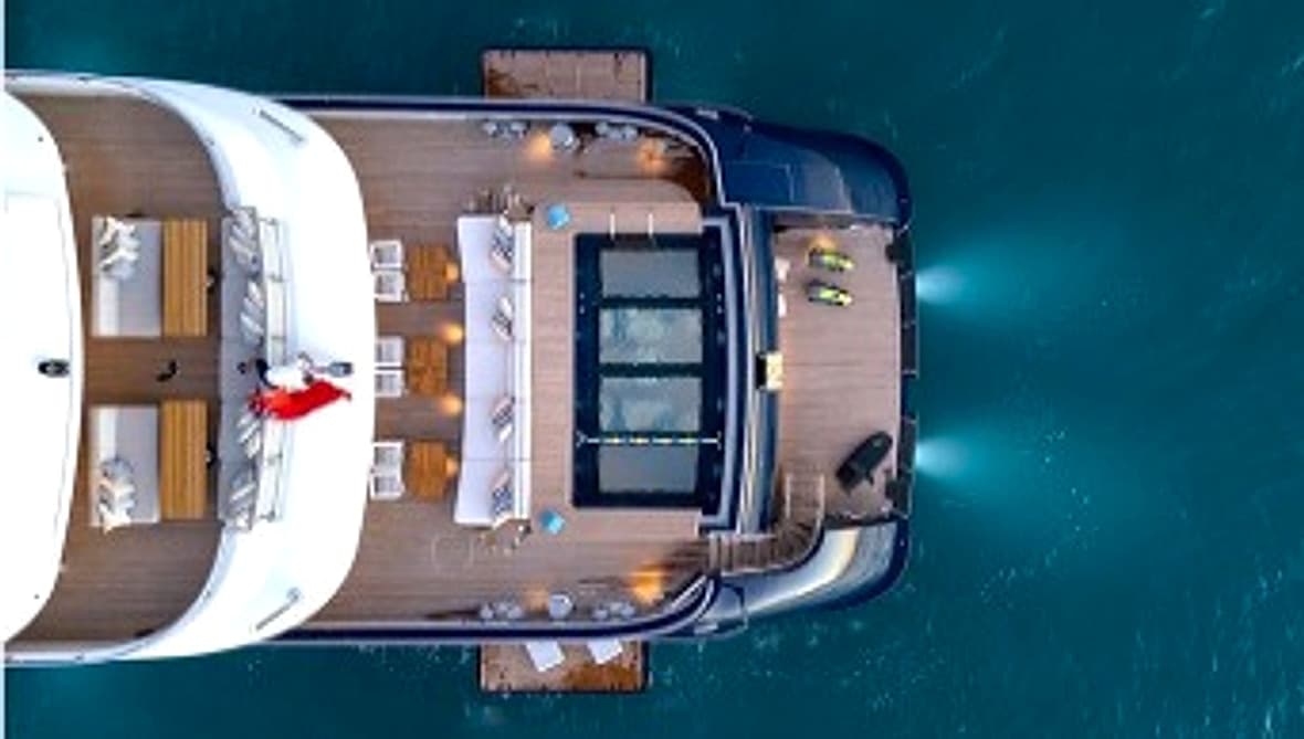 Top-down yacht deck with pool and tender access