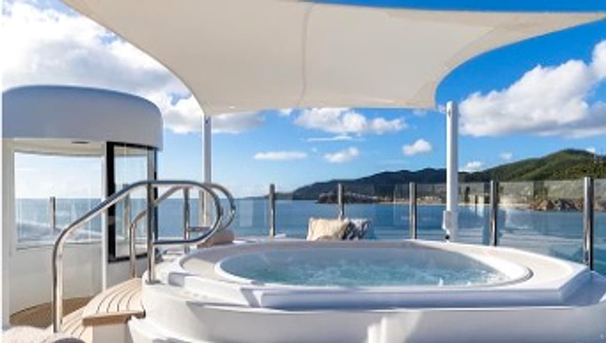 Yacht upper deck jacuzzi with sea and coastline view
